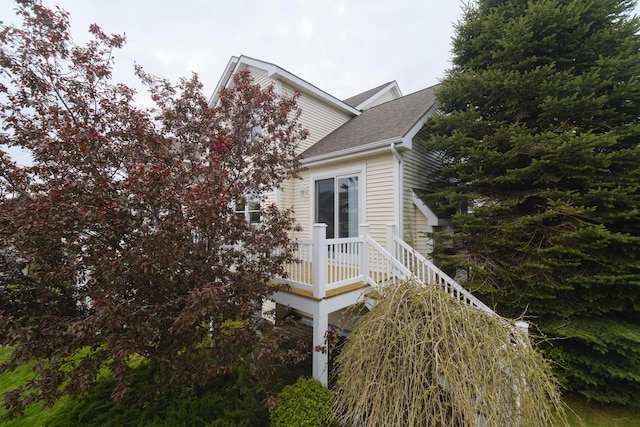 70 Spinnaker Dr, Manistee, MI 49660 - view of side of property with a shingled roof