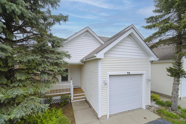 70 Spinnaker Dr, Manistee, MI 49660 - ranch-style house featuring driveway, covered porch, a garage, and a shingled roof