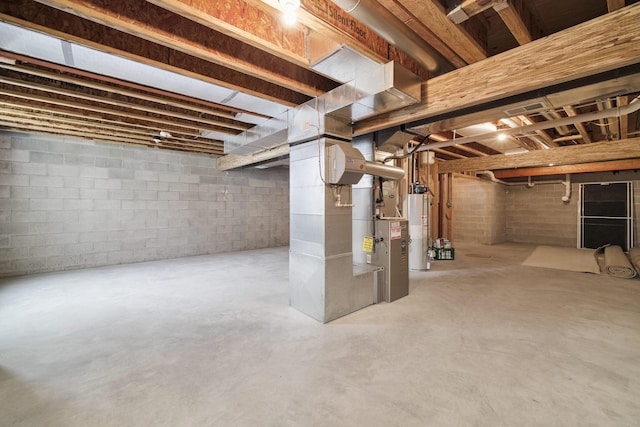 70 Spinnaker Dr, Manistee, MI 49660 - unfinished basement featuring gas water heater and heating unit