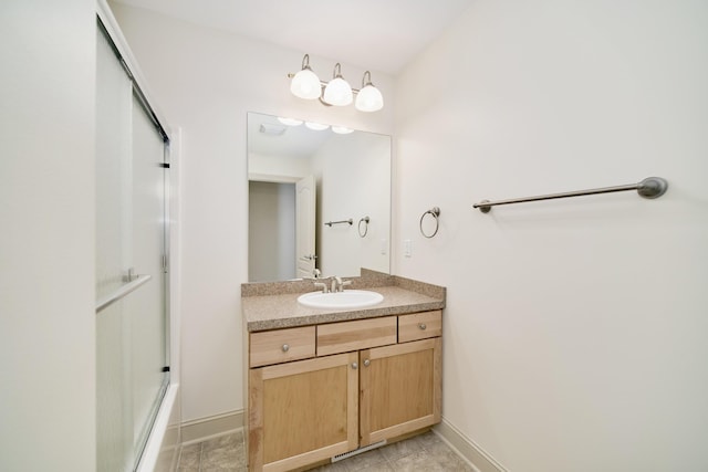 70 Spinnaker Dr, Manistee, MI 49660 - full bathroom with baseboards, vanity, and shower / bath combination with glass door