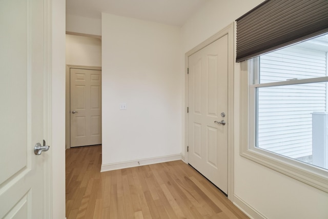 70 Spinnaker Dr, Manistee, MI 49660 - entrance foyer with light wood-style floors, baseboards, and plenty of natural light