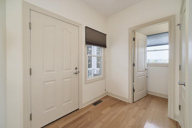 70 Spinnaker Dr, Manistee, MI 49660 - entrance foyer featuring light wood finished floors, healthy amount of natural light, and baseboards