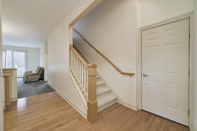 70 Spinnaker Dr, Manistee, MI 49660 - staircase with wood finished floors and baseboards