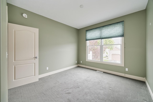 70 Spinnaker Dr, Manistee, MI 49660 - empty room with carpet floors, baseboards, and a smoke detector