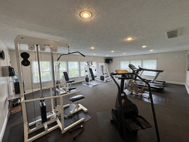70 Spinnaker Dr, Manistee, MI 49660 - workout area featuring a textured ceiling, healthy amount of natural light, baseboards, and recessed lighting