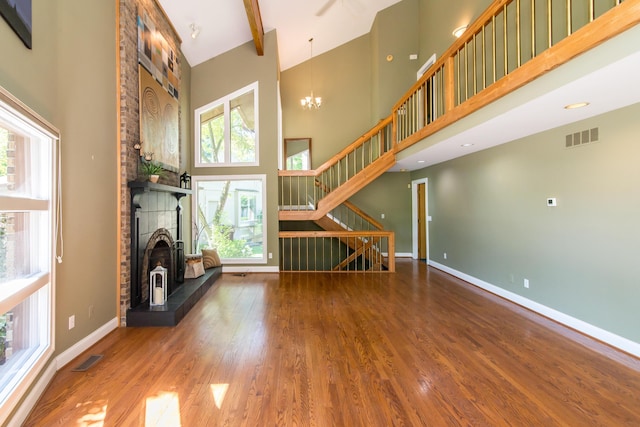 3007 Cedarbrook Rd, Ann Arbor, MI 48105 - unfurnished living room with stairway, a towering ceiling, wood finished floors, baseboards, and a chandelier