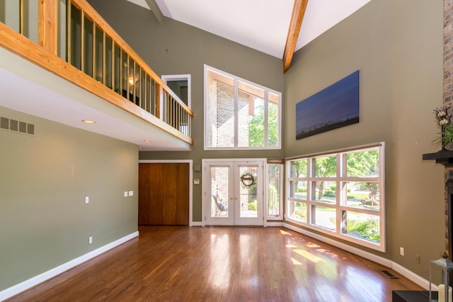 3007 Cedarbrook Rd, Ann Arbor, MI 48105 - unfurnished living room with a towering ceiling, baseboards, wood finished floors, french doors, and a fireplace
