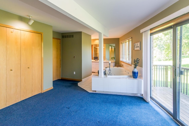 3007 Cedarbrook Rd, Ann Arbor, MI 48105 - bathroom featuring a whirlpool tub, carpet floors, and baseboards