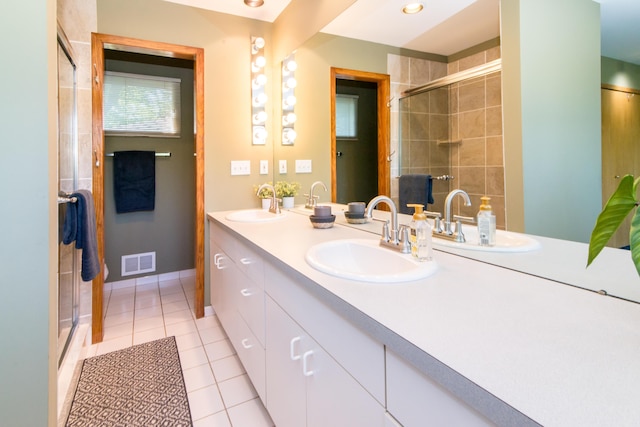 3007 Cedarbrook Rd, Ann Arbor, MI 48105 - bathroom featuring double vanity, a tile shower, tile patterned floors, and baseboards