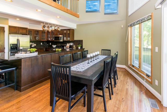 3007 Cedarbrook Rd, Ann Arbor, MI 48105 - dining room featuring light wood-type flooring, baseboards, a towering ceiling, and recessed lighting
