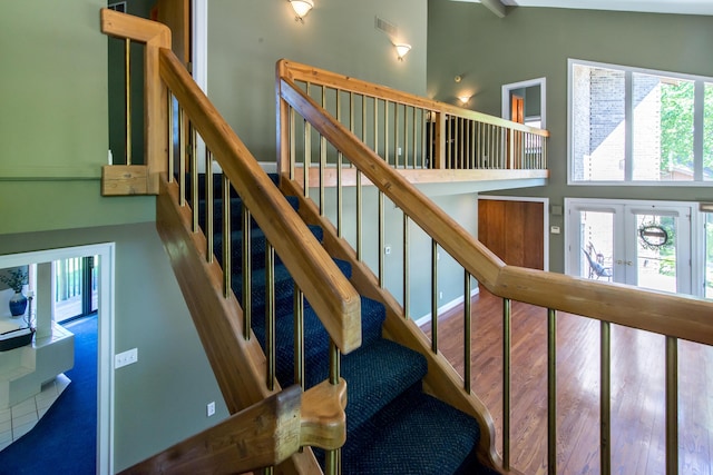 3007 Cedarbrook Rd, Ann Arbor, MI 48105 - stairs with french doors, a towering ceiling, and wood finished floors