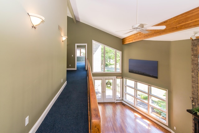 3007 Cedarbrook Rd, Ann Arbor, MI 48105 - hallway with beam ceiling, baseboards, and a high ceiling