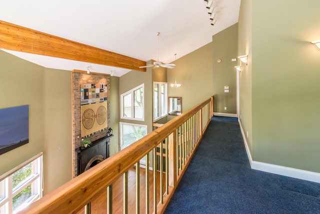 3007 Cedarbrook Rd, Ann Arbor, MI 48105 - hallway with baseboards, dark colored carpet, rail lighting, beamed ceiling, and high vaulted ceiling