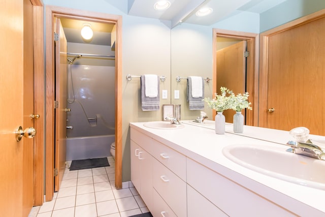 3007 Cedarbrook Rd, Ann Arbor, MI 48105 - full bath featuring double vanity, toilet, tile patterned floors, and washtub / shower combination