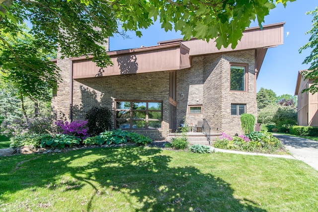 3007 Cedarbrook Rd, Ann Arbor, MI 48105 - back of property featuring a yard and brick siding
