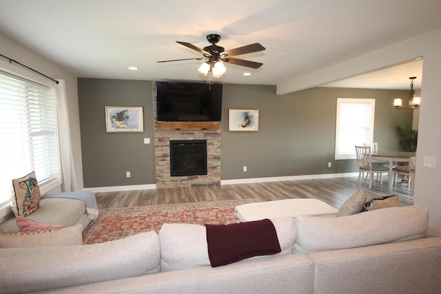 10141 S 33rd St, Vicksburg, MI 49097 - living area featuring wood finished floors, a ceiling fan, a stone fireplace, baseboards, and recessed lighting