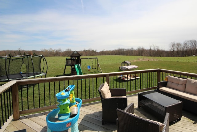 10141 S 33rd St, Vicksburg, MI 49097 - wooden terrace featuring a trampoline, an outdoor hangout area, a playground, and a yard