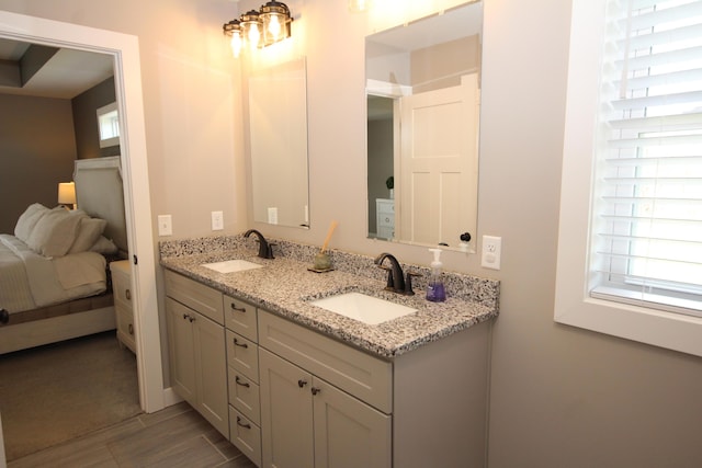 10141 S 33rd St, Vicksburg, MI 49097 - full bathroom with double vanity, connected bathroom, and wood finished floors