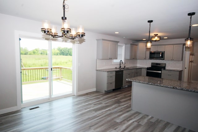 10141 S 33rd St, Vicksburg, MI 49097 - kitchen with appliances with stainless steel finishes, gray cabinets, backsplash, light stone counters, and recessed lighting