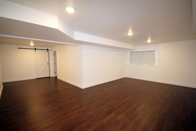 10141 S 33rd St, Vicksburg, MI 49097 - finished below grade area with a barn door, dark wood-style floors, and recessed lighting
