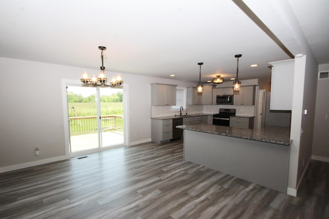 10141 S 33rd St, Vicksburg, MI 49097 - kitchen with black appliances, gray cabinets, a peninsula, dark wood-style floors, and a chandelier