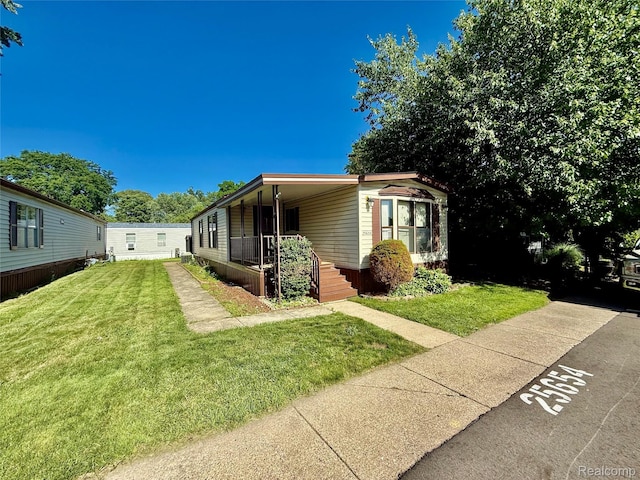 25654 Madison St, Novi, MI 48375 - view of front of home with a front yard and a porch