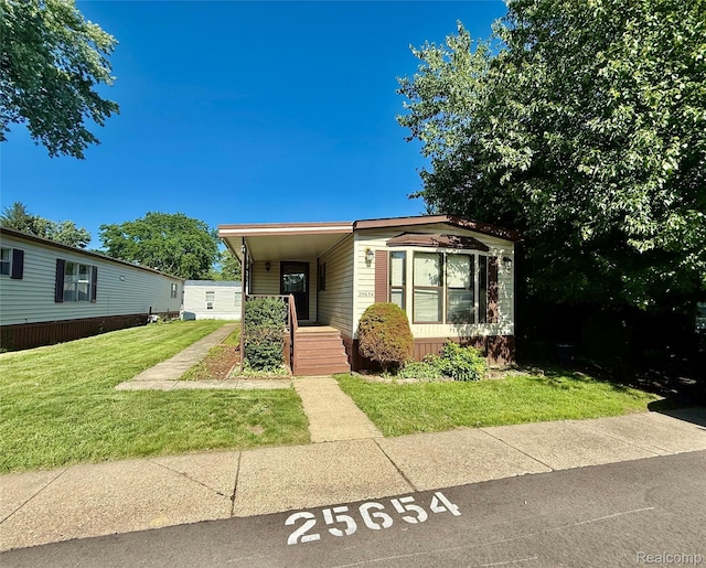25654 Madison St, Novi, MI 48375 - manufactured / mobile home with a front yard and uncovered parking