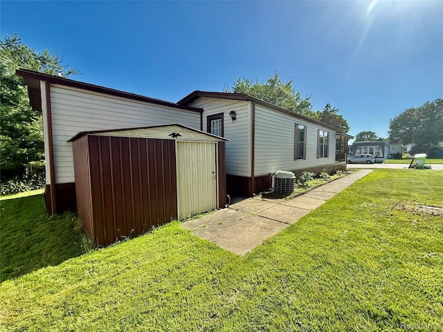 25654 Madison St, Novi, MI 48375 - view of side of property featuring a storage unit and a lawn