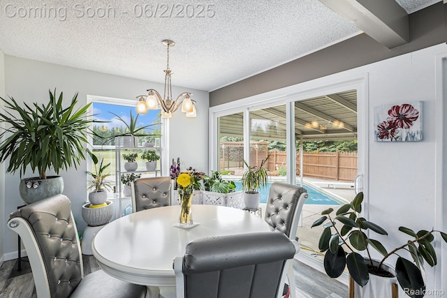 7453 Baldwin Rd, Swartz Creek, MI 48473 - dining room with wood finished floors, a chandelier, and a textured ceiling