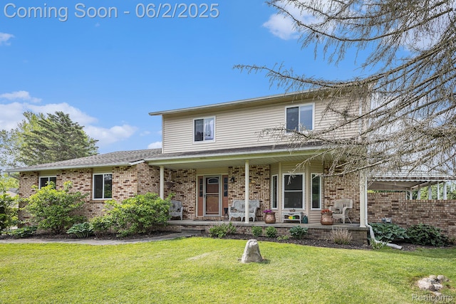 7453 Baldwin Rd, Swartz Creek, MI 48473 - traditional-style home featuring brick siding, covered porch, and a front yard