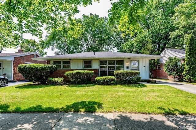 1019 Symes Ct, Royal Oak, MI 48067 - ranch-style house featuring board and batten siding, brick siding, and a front yard