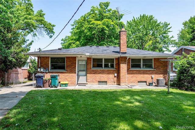 1019 Symes Ct, Royal Oak, MI 48067 - rear view of property featuring brick siding, a chimney, and central AC