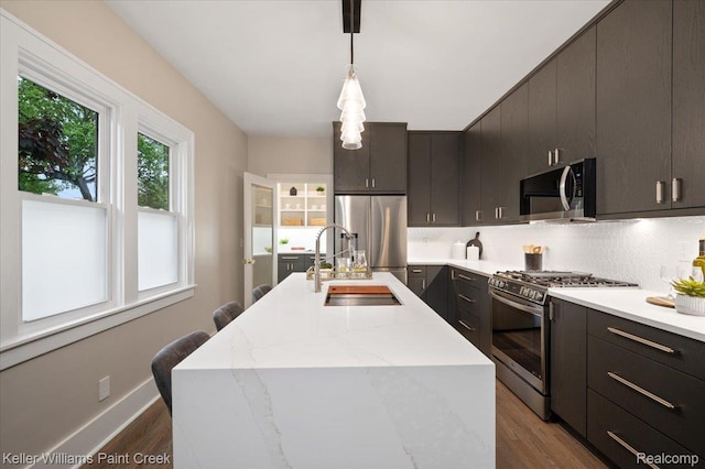 520 Kayser Ave, Birmingham, MI 48067 - kitchen featuring stainless steel appliances, a sink, wood finished floors, and hanging light fixtures