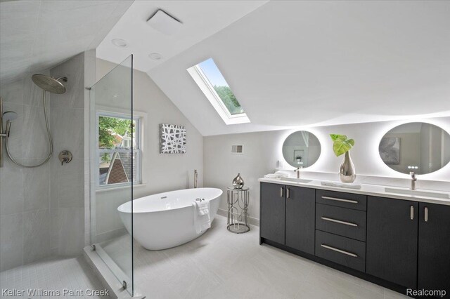520 Kayser Ave, Birmingham, MI 48067 - full bathroom featuring a skylight, tiled shower, a freestanding tub, vaulted ceiling, and double vanity