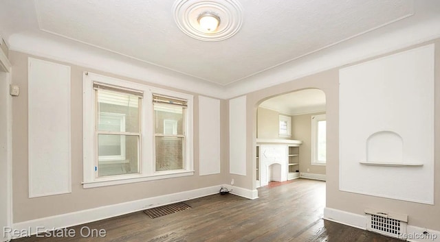 15344 Hartwell St, Dearborn Heights, MI 48227 - spare room featuring arched walkways, dark wood finished floors, and baseboards