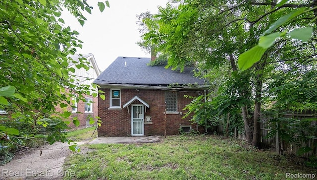 15344 Hartwell St, Dearborn Heights, MI 48227 - rear view of house featuring brick siding and a shingled roof