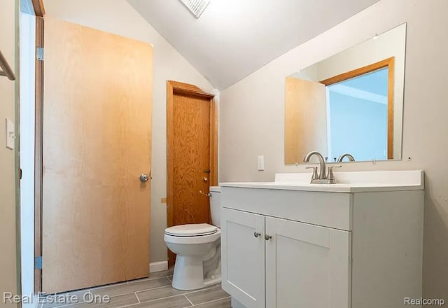 15344 Hartwell St, Dearborn Heights, MI 48227 - bathroom with lofted ceiling, vanity, toilet, and wood finished floors