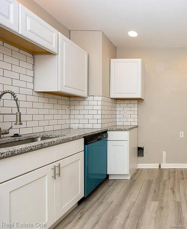15344 Hartwell St, Dearborn Heights, MI 48227 - kitchen featuring dishwasher, light wood-style flooring, a sink, white cabinetry, and tasteful backsplash