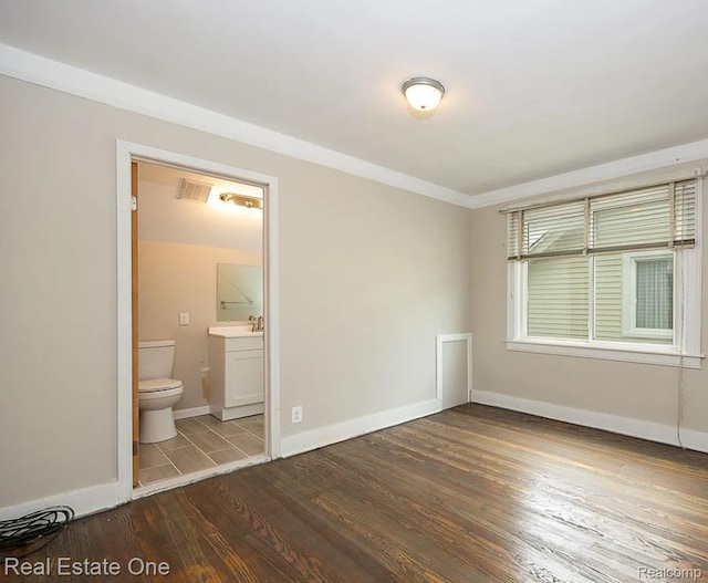 15344 Hartwell St, Dearborn Heights, MI 48227 - unfurnished bedroom with wood finished floors, baseboards, crown molding, and ensuite bathroom