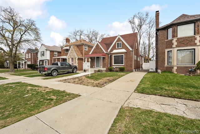 18696 Cherrylawn St, Detroit, MI 48221 - view of front facade featuring brick siding, a front lawn, a residential view, and a chimney