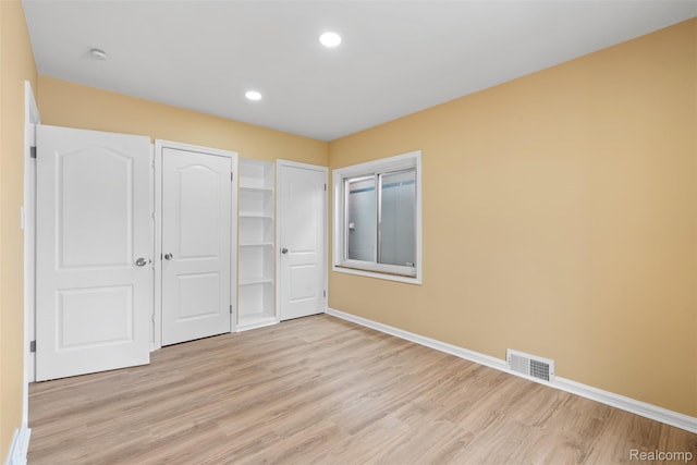 18696 Cherrylawn St, Detroit, MI 48221 - unfurnished bedroom with light wood-style floors, baseboards, and recessed lighting
