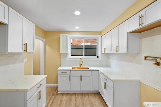 18696 Cherrylawn St, Detroit, MI 48221 - kitchen featuring a sink, light stone counters, backsplash, light wood-style floors, and recessed lighting