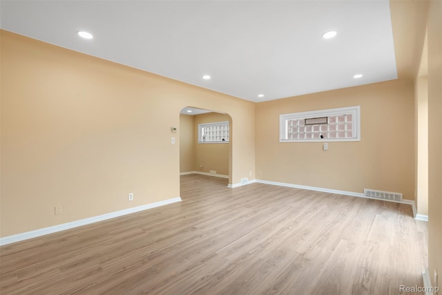 18696 Cherrylawn St, Detroit, MI 48221 - spare room with arched walkways, baseboards, light wood-style flooring, and recessed lighting