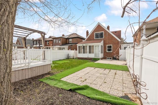 18696 Cherrylawn St, Detroit, MI 48221 - back of property with a sunroom, brick siding, a patio area, a chimney, and a pergola