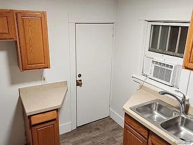 513 W Kilborn St, Lansing, MI 48906 - kitchen featuring brown cabinets, a sink, and light countertops