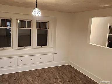 513 W Kilborn St, Lansing, MI 48906 - spare room with baseboards and dark wood finished floors
