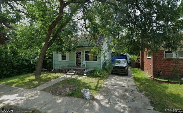 17224 Waveney St, Detroit, MI 48224 - obstructed view of property featuring concrete driveway, a front lawn, and brick siding