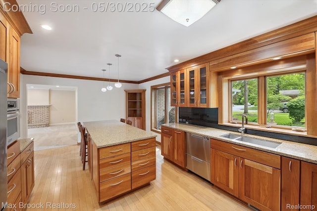 4335 Queens Way, Bloomfield Hills, MI 48304 - kitchen with stainless steel appliances, a sink, brown cabinetry, glass insert cabinets, and light stone counters