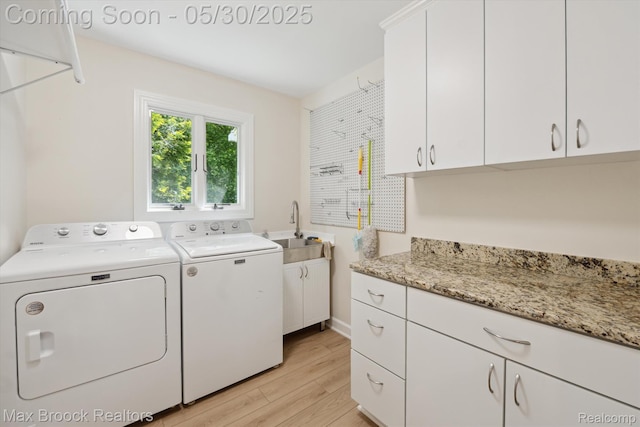 4335 Queens Way, Bloomfield Hills, MI 48304 - laundry room featuring separate washer and dryer, cabinet space, and light wood-style floors