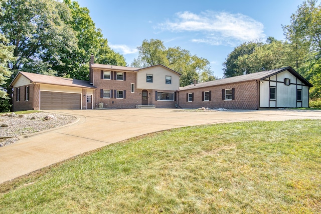 610 Birch St, Big Rapids, MI 49307 - tri-level home with brick siding, driveway, a garage, and a front lawn